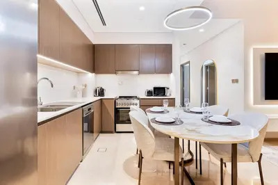 a kitchen and dining room with a table and chairs at 2Bed with spectacular Burj Khalifa & fountain view in Dubai
