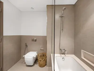 a bathroom with a toilet and a bath tub at 2BR balcony Downtown with Burj Khalifa and Fountain View in Dubai