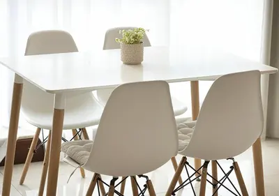 a white table with four chairs and a potted plant at Cozy 2 Br Heart of Palm Jumeirah in Dubai
