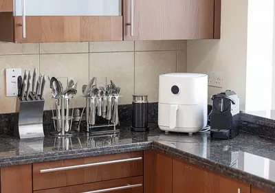 a kitchen counter with utensils on a counter top at Cozy 2 Br Heart of Palm Jumeirah in Dubai
