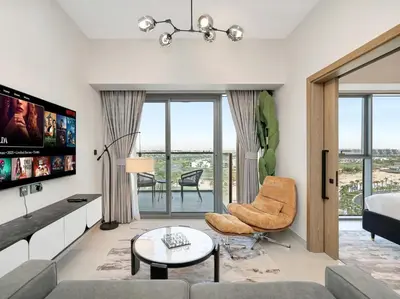 a living room with a couch and a tv at Golf View Modern Comfort Perfect for 3 Guests in Dubai