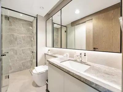 a bathroom with a sink and a toilet and a mirror at Golf View Modern Comfort Perfect for 3 Guests in Dubai
