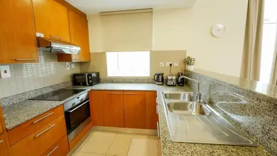 a kitchen with a sink and a counter top at Modern studio in Business Bay- 5 min to Dubai Mall in Dubai
