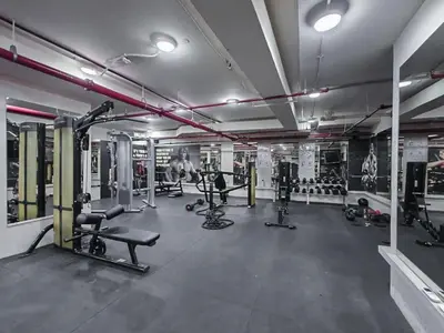 a gym with several treadmills and machines at Modern studio in Business Bay- 5 min to Dubai Mall in Dubai