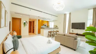 a large living room with a bed and a couch at Modern studio in Business Bay- 5 min to Dubai Mall in Dubai