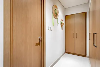 a room with a door and a hallway at Commodious 3BR Apartment Canal View Creek Harbor in Dubai