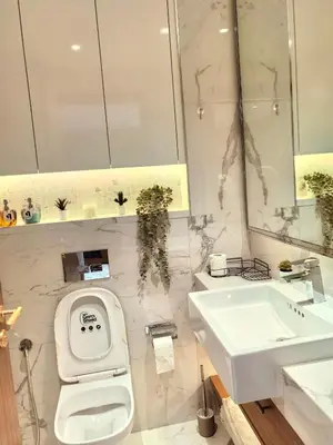 a bathroom with a toilet and a sink at 10 min to Burj Khalifa 1BR in Hotel-style building Luxury Stay in Dubai