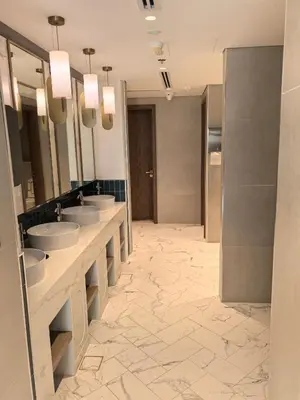 a bathroom with a row of sinks and mirrors at 10 min to Burj Khalifa 1BR in Hotel-style building Luxury Stay in Dubai