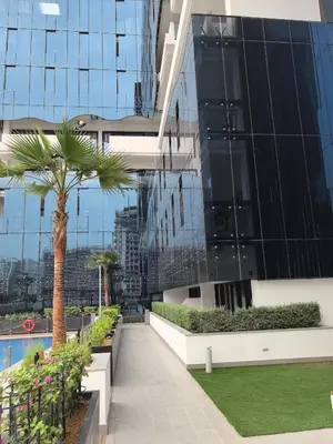 a palm tree on the side of a building at 10 min to Burj Khalifa 1BR in Hotel-style building Luxury Stay in Dubai