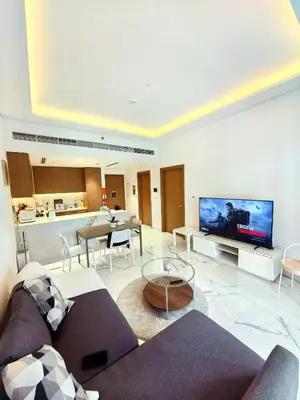 a living room with a couch and a flat screen tv at 10 min to Burj Khalifa 1BR in Hotel-style building Luxury Stay in Dubai