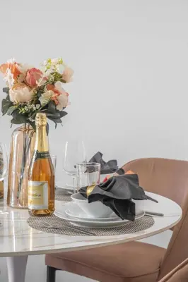 a table with a plate and a bottle of wine at Frank Porter - Marina Wharf 1 in Dubai