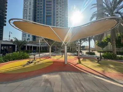 a sculpture in a park in a city at Frank Porter - Lakepoint N2 in Dubai