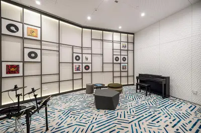 a room with a piano and chairs and pictures on the wall at Marina Horizon by LIV High Floor 1BR, For 5 Guests, Dual Gyms & Marina View in Dubai