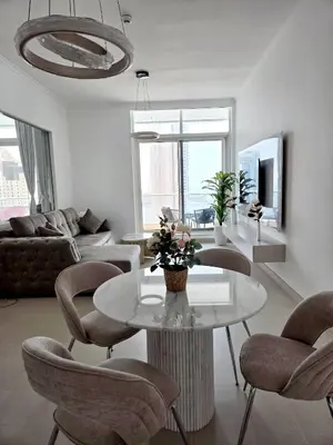 a living room with a table and chairs at Apartment in Dubai Marina with Sea View & Balcony & Pool in Dubai