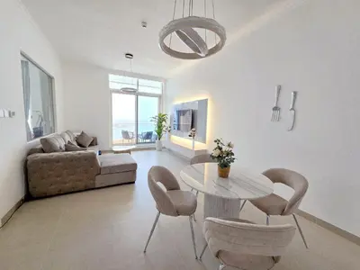 a living room with a table and chairs and a couch at Apartment in Dubai Marina with Sea View & Balcony & Pool in Dubai