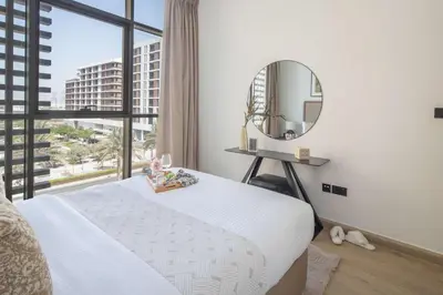 a bedroom with a large bed and a mirror at Frank Porter - Acacia, Park Heights Tower A in Dubai