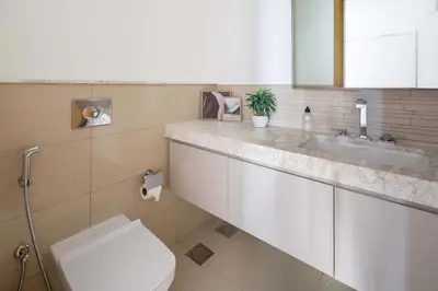 a bathroom with a toilet and a sink at Frank Porter - Acacia, Park Heights Tower A in Dubai