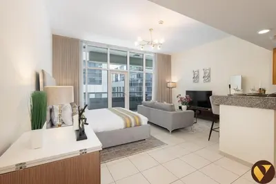 a hotel room with a bed and a living room at Vogue Business Bay - Bay Square Close to Downtown, Burj Khalifa and Dubai Mall, Studio Apartment with Balcony and City View, Access to all Amenities in Dubai
