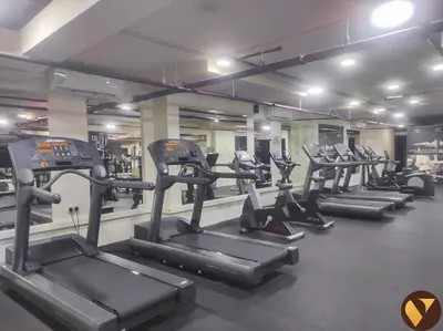 a row of tread machines in a gym at Vogue Business Bay - Bay Square Close to Downtown, Burj Khalifa and Dubai Mall, Studio Apartment with Balcony and City View, Access to all Amenities in Dubai