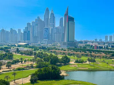a view of a city skyline with a park and a lake at HiGuests - 2 BR Escape Golf View Haven in The Greens in Dubai