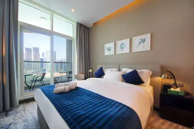 a bedroom with a large bed and a large window at King Bed Suite - Canal Views - Pool, Gym & Balcony in Dubai