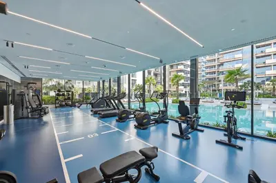 a gym with treadmills and exercise equipment in a building at New Cozy Studio, Ideal for 2 in Kensington Waters in Dubai