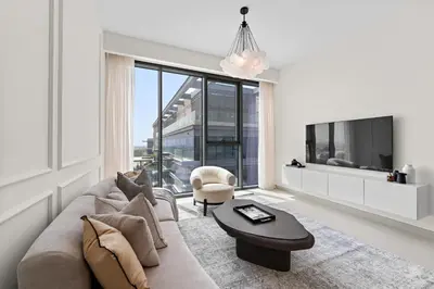 a living room with a couch and a tv at Parkside 2BR plus Maid Canal Front in Dubai