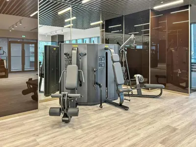 a gym with chairs and machines in a room at Parkside 2BR plus Maid Canal Front in Dubai