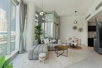 a living room with a couch and a table at Modern 2 Bedroom in Dubai Marina - Sea View in Dubai