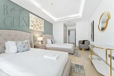 a bedroom with a bed and a couch and a mirror at Stunning Full Sea View 3BR Luxurious Palm Jumeirah in Dubai