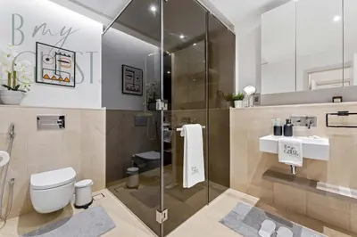 a bathroom with a shower and a toilet and a sink at Stunning Full Sea View 3BR Luxurious Palm Jumeirah in Dubai