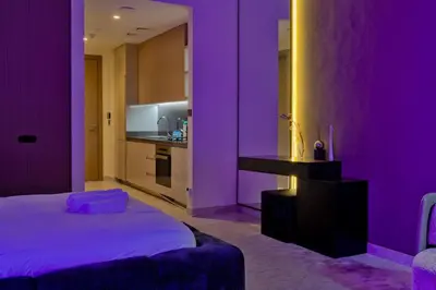 a purple room with a bed and a kitchen at Stylish Studio with Stunning City Views in Dubai