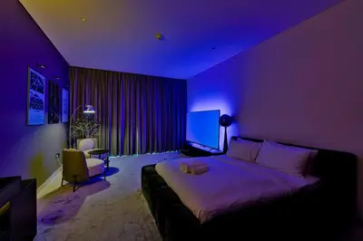 a purple bedroom with a bed and a tv at Stylish Studio with Stunning City Views in Dubai