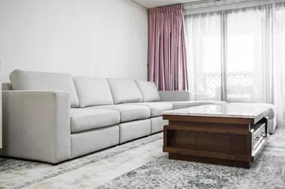 a living room with a couch and a coffee table at SettlerHomes - Seaside Lux Escape With Calm Sea View in Dubai
