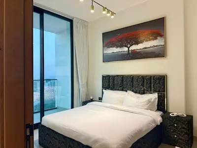 a bedroom with a bed and a large window at Modern 1BD APT In Binghatti Burj Khalifa Skyline in Dubai