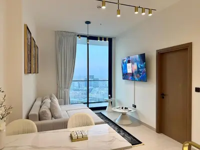 a living room with a couch and a large window at Modern 1BD APT In Binghatti Burj Khalifa Skyline in Dubai