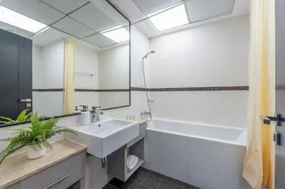 a bathroom with a sink and a tub and a mirror at Luxury 3BR Dubai Marina Sea & Ain Dubai View in Dubai