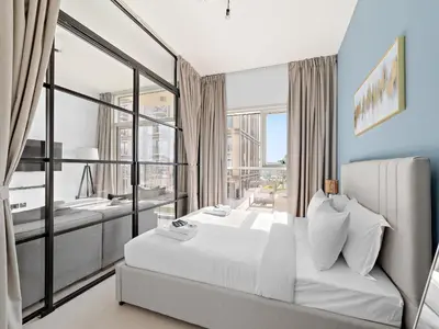 a bedroom with a bed and a large window at Classic Luxe 2BDR in Collective in Dubai
