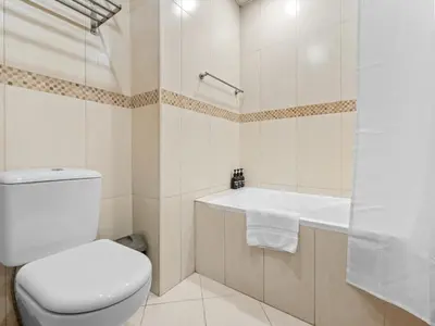 a bathroom with a toilet and a bath tub at 1BR in JLT, Steps from Metro, Marina & Mall in Dubai