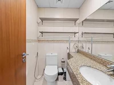 a bathroom with a toilet and a sink at 1BR in JLT, Steps from Metro, Marina & Mall in Dubai