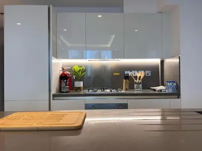a kitchen with a counter with a wooden cutting board at Mahenti - Mesmerizing views of The Burj & Downtown Dubai in Dubai