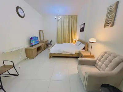 a living room with a bed and a couch at Mahenti - Elite 1 · Large balcony with all u need in Dubai