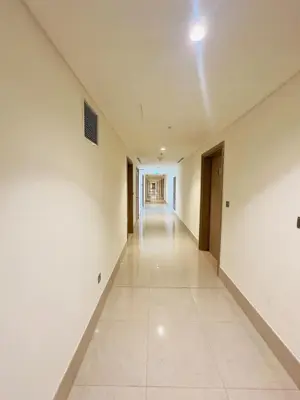 an empty hallway with white walls and tile floors at Mahenti – Elegant Studio Apartment | Azizi Riviera in Dubai