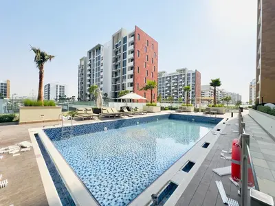 a swimming pool on the roof of a building at Mahenti – Elegant Studio Apartment | Azizi Riviera in Dubai