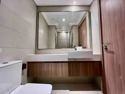 a bathroom with a sink and a mirror at Mahenti - Contemporary Studio Living in Meydan in Dubai