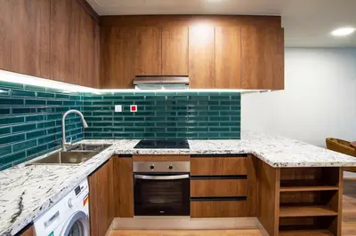 a kitchen with a sink and a stove top oven at Stylish 2BR Balcony Palm Jumeirah Views in Dubai