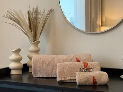 a bathroom with two towels on a table with a mirror at Mahenti- Chic 1BR with Burj & Downtown View in Dubai