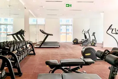 a gym with several treadmills and exercise bikes at Mahenti - 1BR - Stunning Lake & Burj Khalifa Views in Dubai