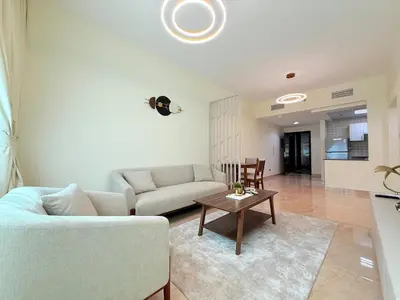 a living room with a couch and a table at Mahenti - 1BR in Dubai Marina - Near Metro & Tram in Dubai