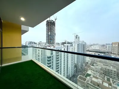 a balcony with a view of a city at Mahenti - Sunlit Spacious Apartment in JVC in Dubai